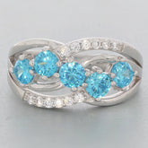 Blue Topaz Sterling Silver Ring featuring five sparkling blue gemstones and accent stones, elegantly intertwined design.